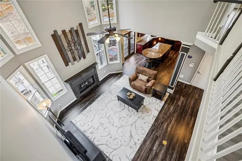a view of a chair and tables in backyard of the house