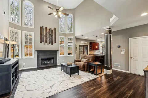 a living room with furniture a flat screen tv and a fireplace