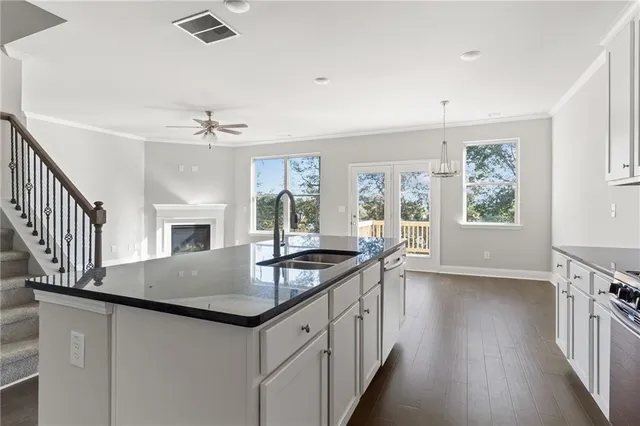 a kitchen with granite countertop a sink and stove