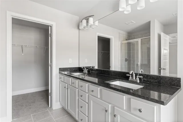 a bathroom with double sink and a mirror
