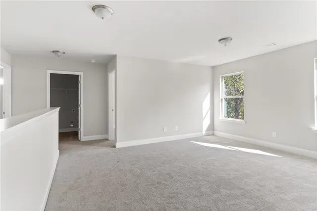 an empty room with windows and closet