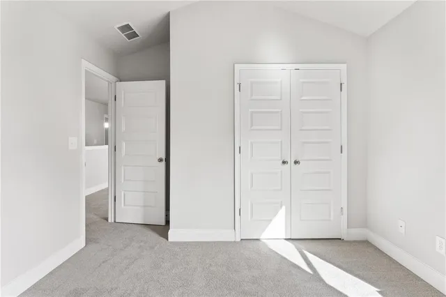 an empty room with closet area