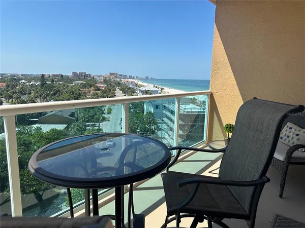 a view of balcony with table and chairs