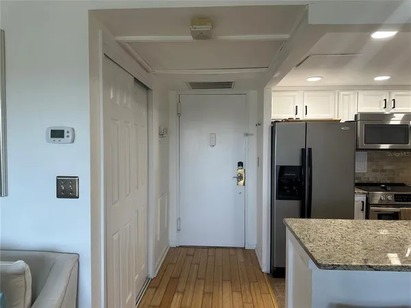 a kitchen with stainless steel appliances granite countertop a refrigerator and a sink