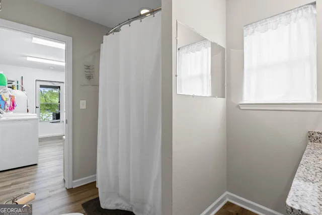 a view of small space with wooden floor and windows
