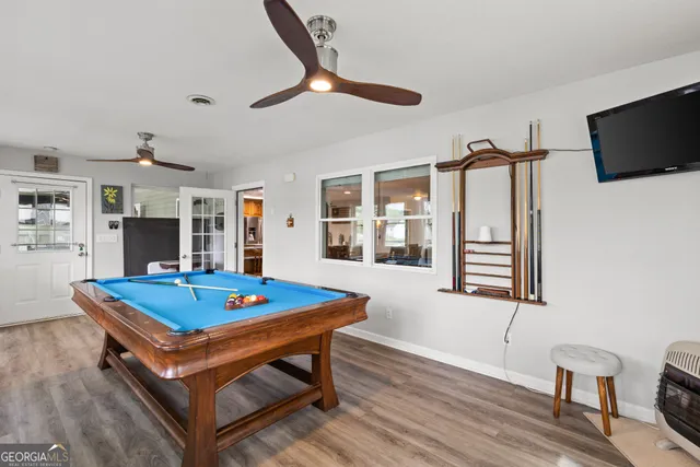 a living room with pool table and flat screen tv