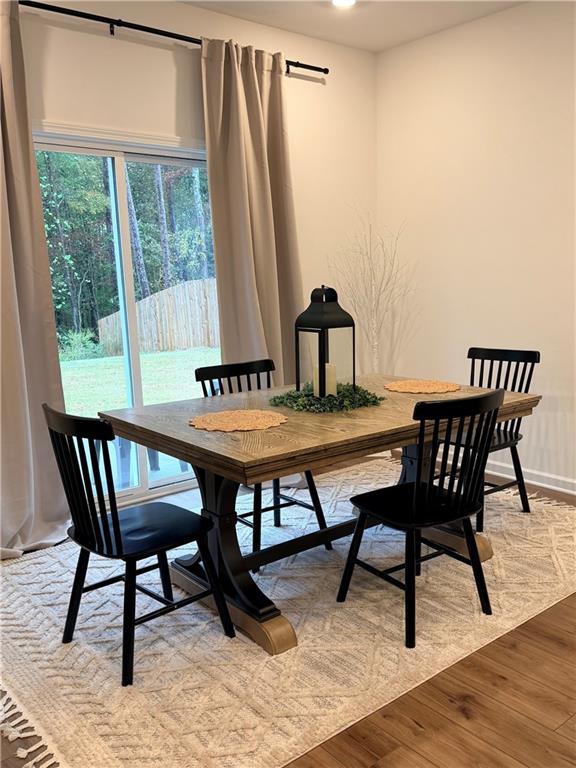 117 Red Maple Way Adairsville, GA 30103 - Photo 12 of 44 a view of a dining room with furniture wooden floor and a window