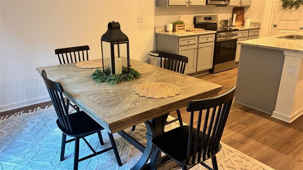 117 Red Maple Way Adairsville, GA 30103 - Photo 13 of 44 a kitchen with a table chairs and wooden floor