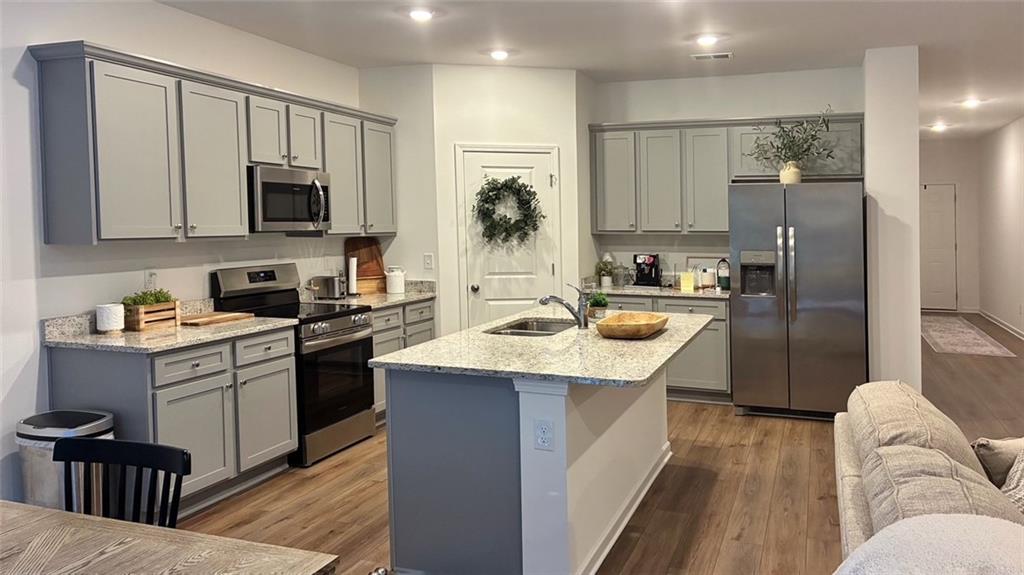 117 Red Maple Way Adairsville, GA 30103 - Photo 3 of 44 a kitchen with stainless steel appliances granite countertop a sink a stove and a refrigerator