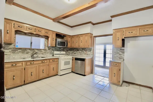 a kitchen with stainless steel appliances granite countertop a refrigerator and wooden cabinets