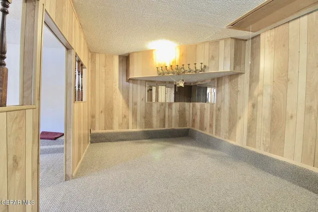 a view of a kitchen with wooden floor and a window