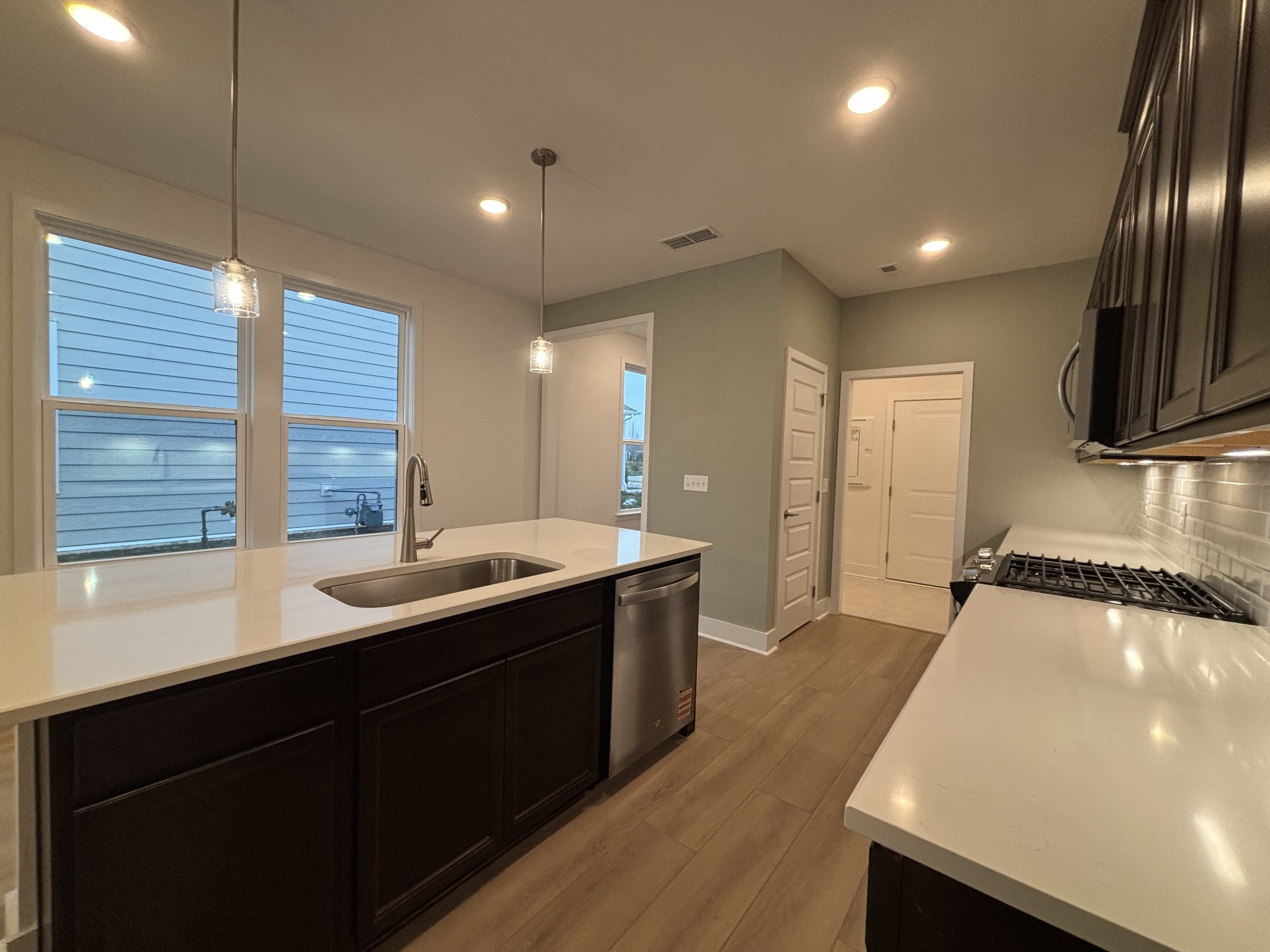 a kitchen with stainless steel appliances a sink stove and cabinets