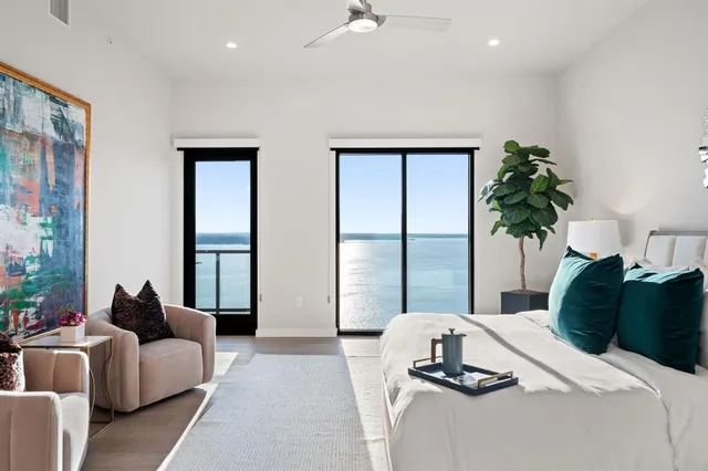 a bedroom with a bed and a large mirror