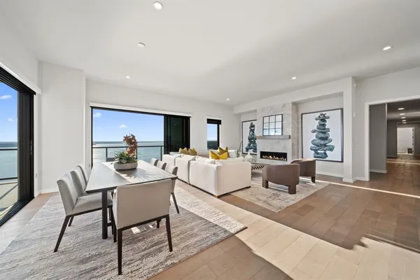 a living room with furniture a flat screen tv and a large window