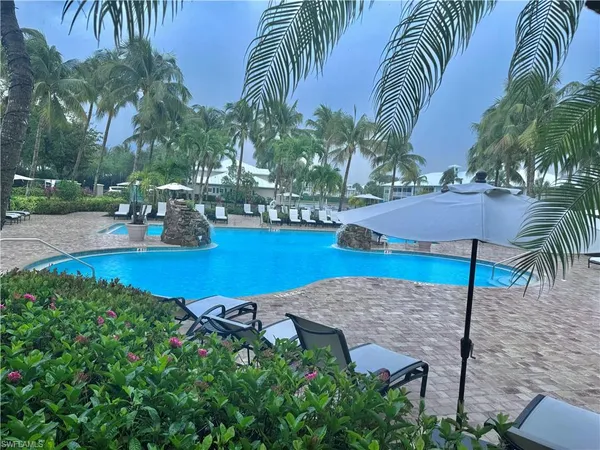 an outdoor space with furniture and umbrella