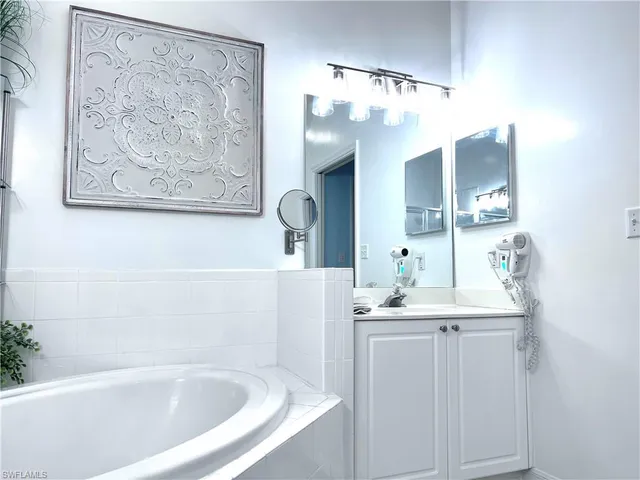 a bathroom with a bathtub and a sink