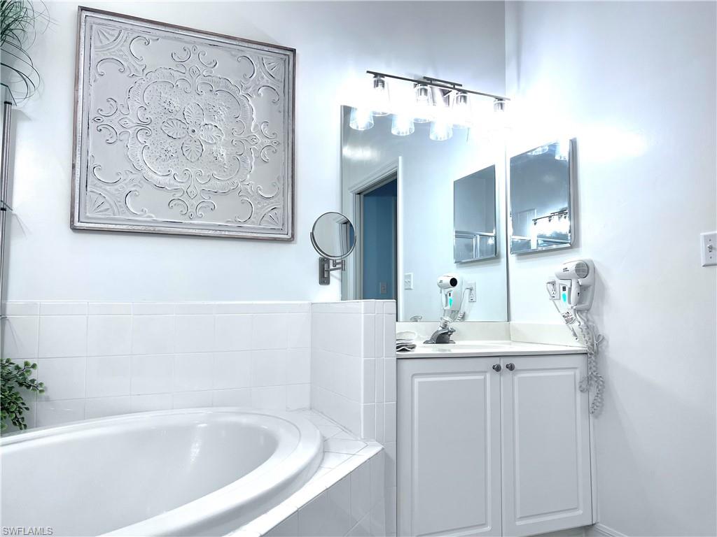 7880 Mahogany Run Lane, Unit 1623 Naples, FL 34113 - Photo 12 of 22 a bathroom with a bathtub and a sink