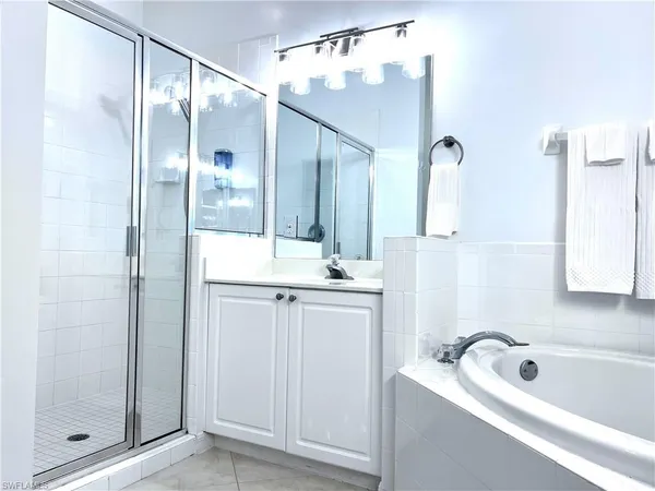 a bathroom with a tub sink and mirror