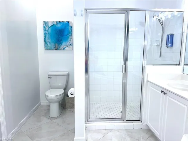 a bathroom with a toilet sink and shower