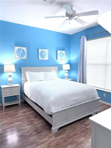 a bedroom with a bed and a ceiling fan