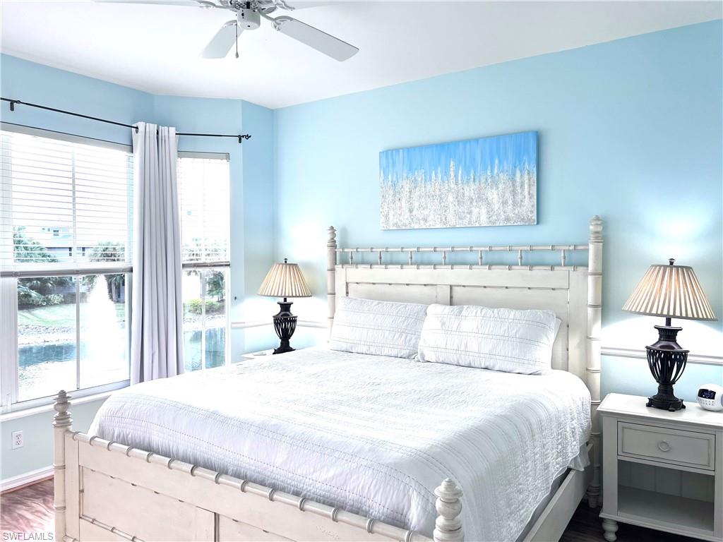 7880 Mahogany Run Lane, Unit 1623 Naples, FL 34113 - Photo 9 of 22 a bedroom with a bed and a chandelier