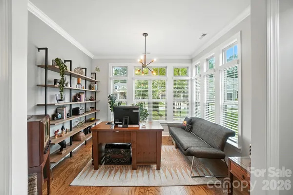 a living room with furniture and a book shelf