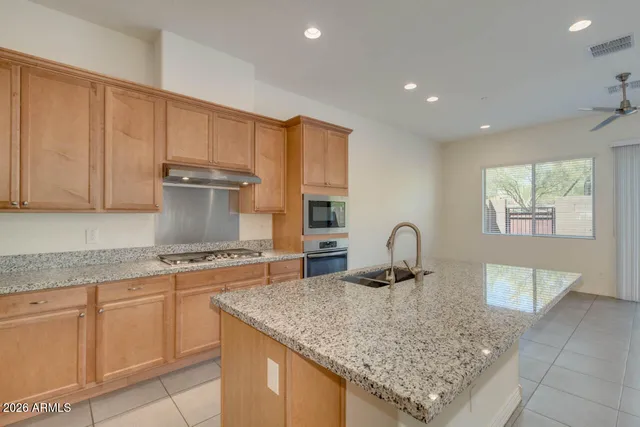 a kitchen with granite countertop a stove a sink and a granite counter tops