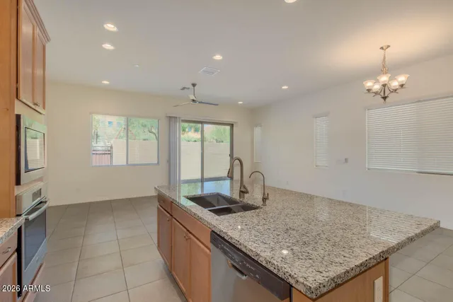 a kitchen with granite countertop sink and natural light