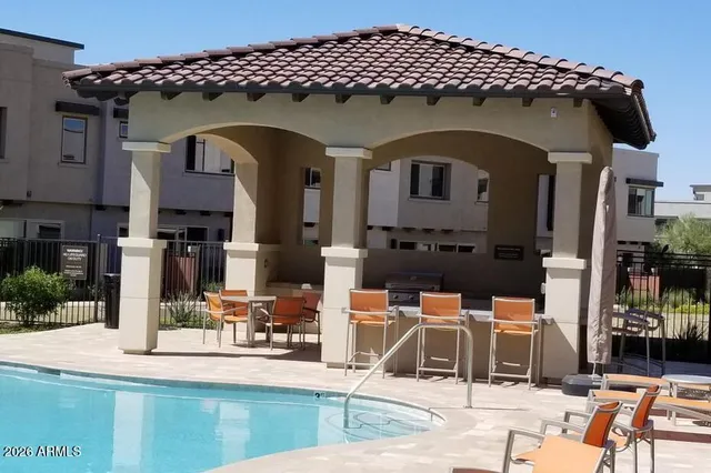 a view of a house with backyard patio and swimming pool