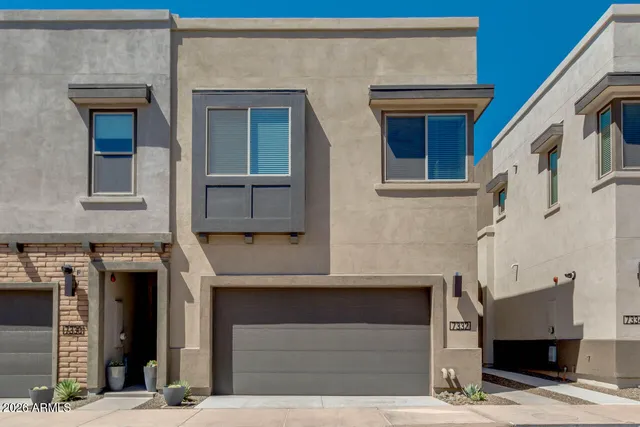a front view of a house with a garage