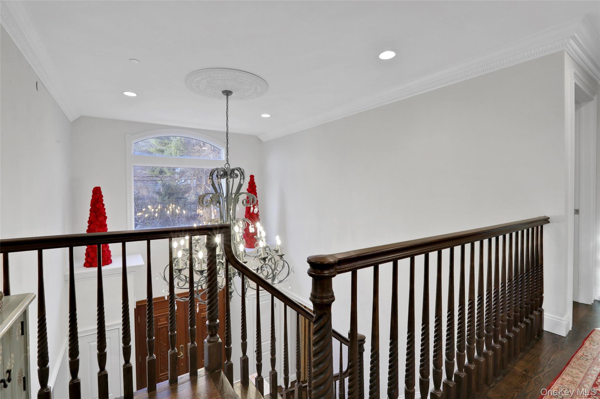 180 Taxter Road Irvington, NY 10533 - Photo 16 of 24 Corridor with crown molding, a chandelier, dark wood finished floors, an upstairs landing, and recessed lighting