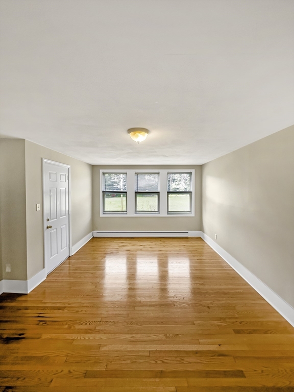109 Hampshire Road, Unit 2 Methuen, MA 01844 - Photo 11 of 29 a view of empty room with wooden floor and fan