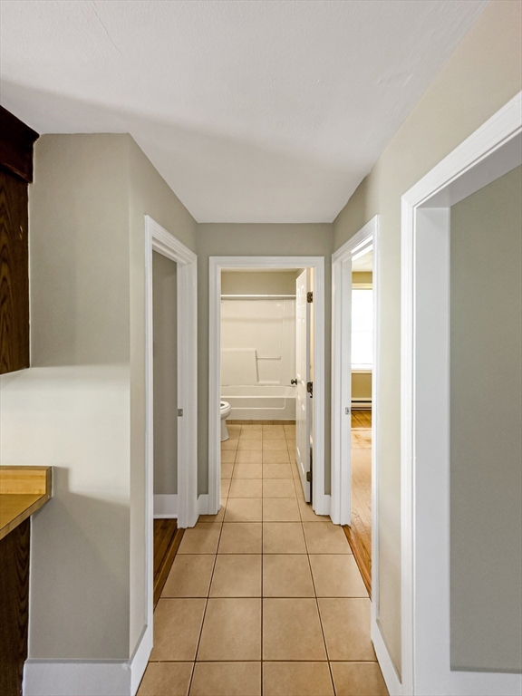 109 Hampshire Road, Unit 2 Methuen, MA 01844 - Photo 14 of 29 a hallway with a furniture and a fireplace