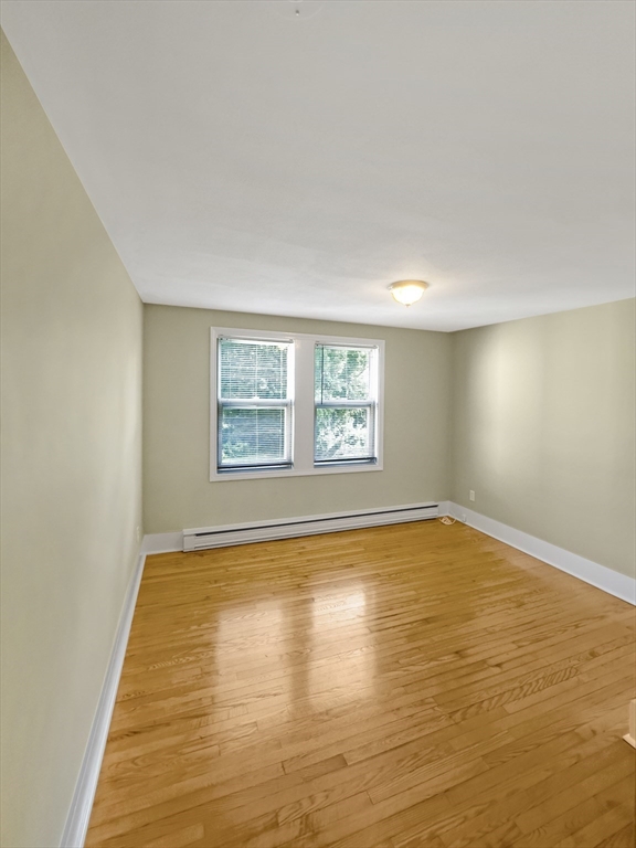 109 Hampshire Road, Unit 2 Methuen, MA 01844 - Photo 20 of 29 a view of empty room with window and wooden floor