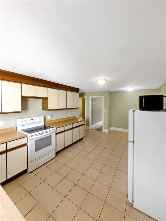 109 Hampshire Road, Unit 2 Methuen, MA 01844 - Photo 4 of 29 a kitchen with stainless steel appliances a sink and a refrigerator