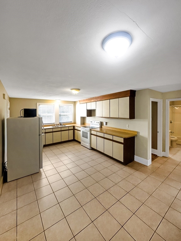 109 Hampshire Road, Unit 2 Methuen, MA 01844 - Photo 7 of 29 a large white kitchen with a sink and cabinets