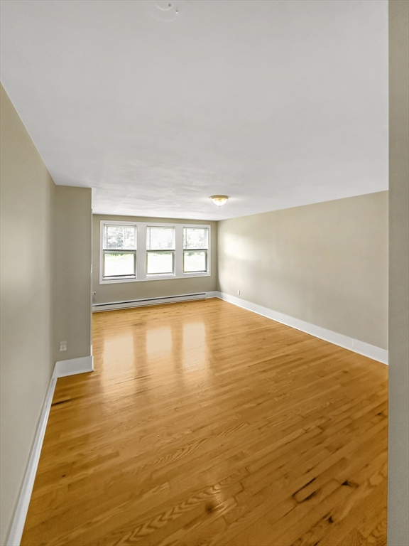 109 Hampshire Road, Unit 2 Methuen, MA 01844 - Photo 10 of 29 wooden floor in an empty room with a window