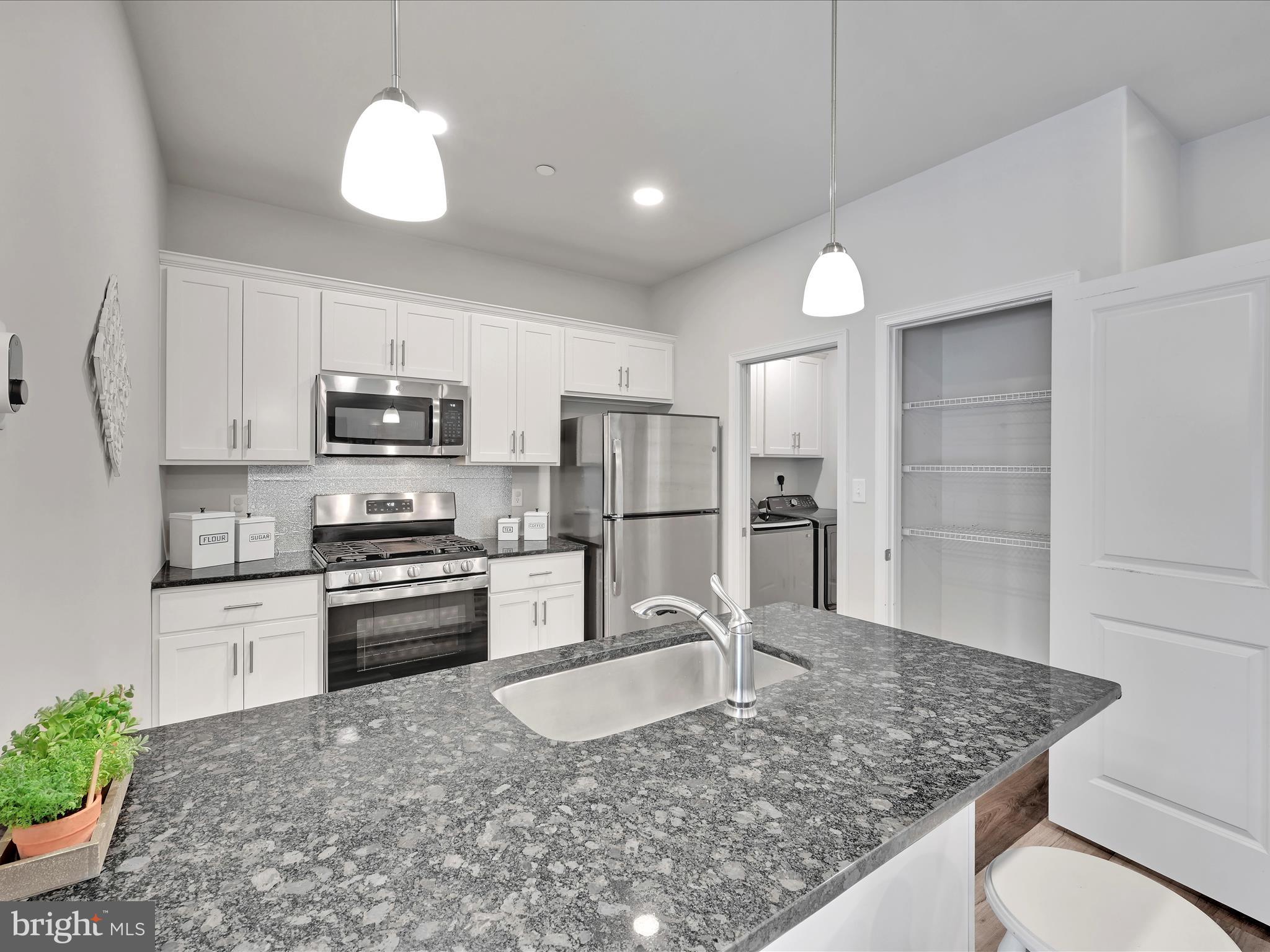 108 Staplehill Court Sinking Spring, PA 19608 - Photo 12 of 33 a kitchen with stainless steel appliances granite countertop a sink refrigerator and microwave