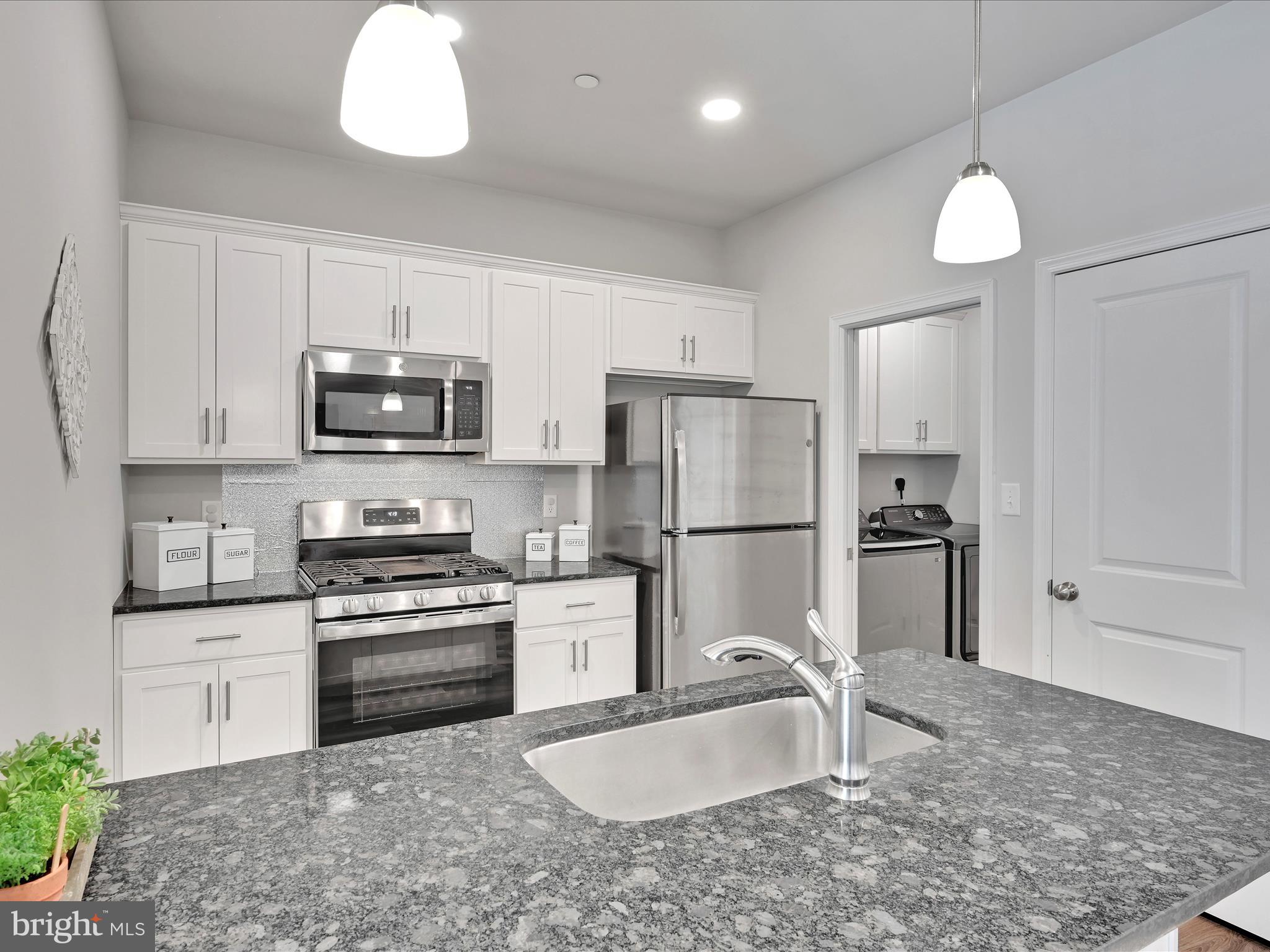 108 Staplehill Court Sinking Spring, PA 19608 - Photo 13 of 33 a kitchen with stainless steel appliances granite countertop a sink a stove a refrigerator cabinets and a counter top space