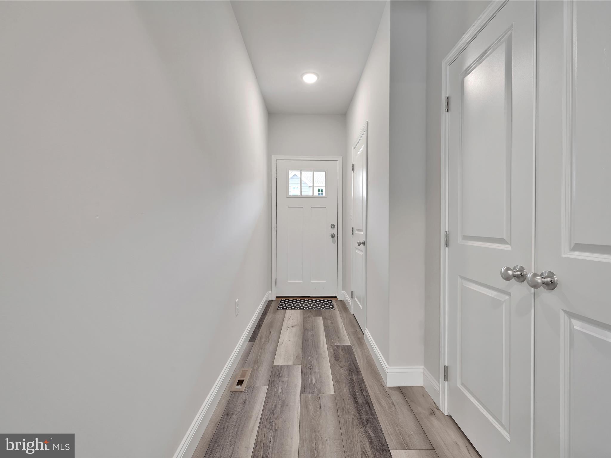 108 Staplehill Court Sinking Spring, PA 19608 - Photo 5 of 33 a view of a hallway with wooden floor and a bathroom