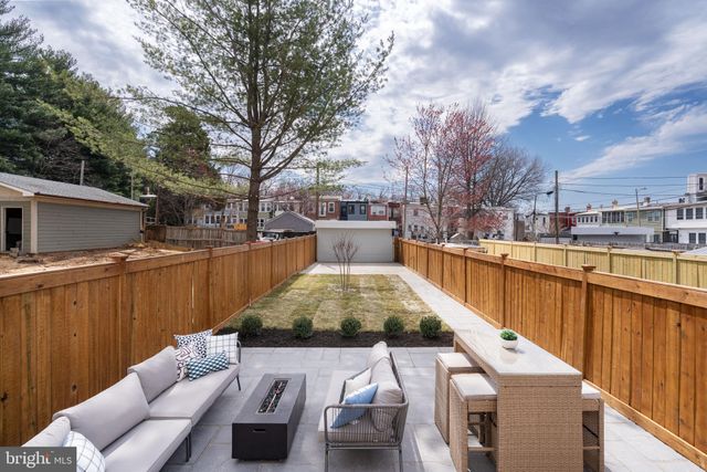 a view of a patio with couches next to a yard