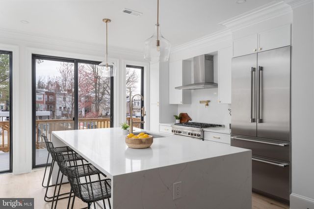 a kitchen with a table chairs and refrigerator