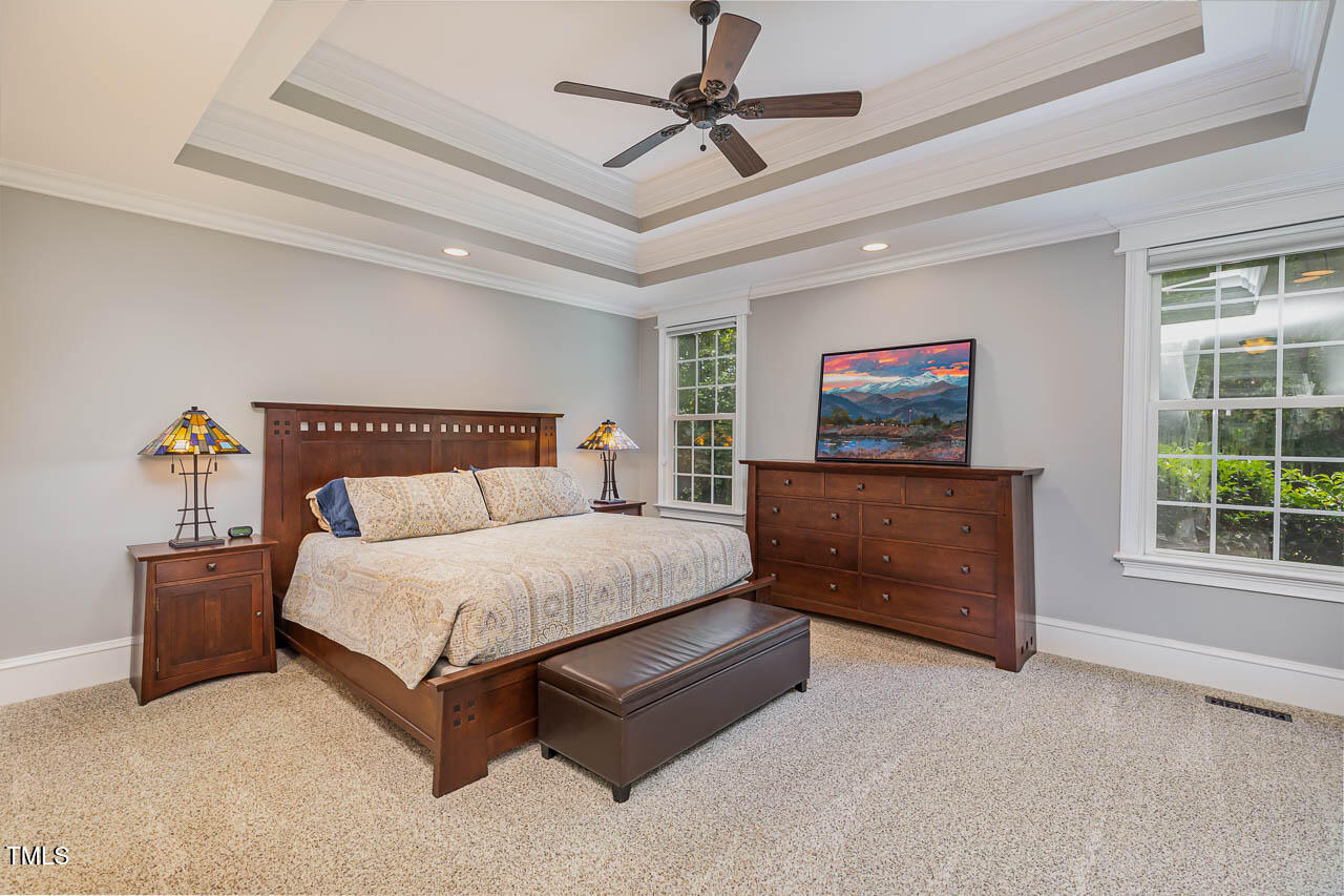 1097 Tacketts Pond Drive Raleigh, NC 27614 - Photo 13 of 38 a bedroom with a bed and a chandelier