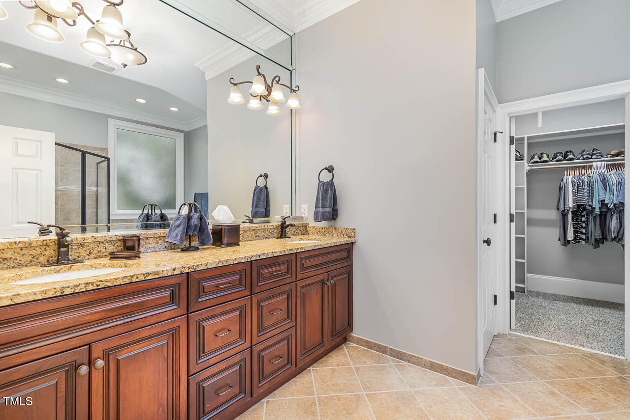 1097 Tacketts Pond Drive Raleigh, NC 27614 - Photo 15 of 38 a spacious bathroom with a granite countertop sink a mirror and shower