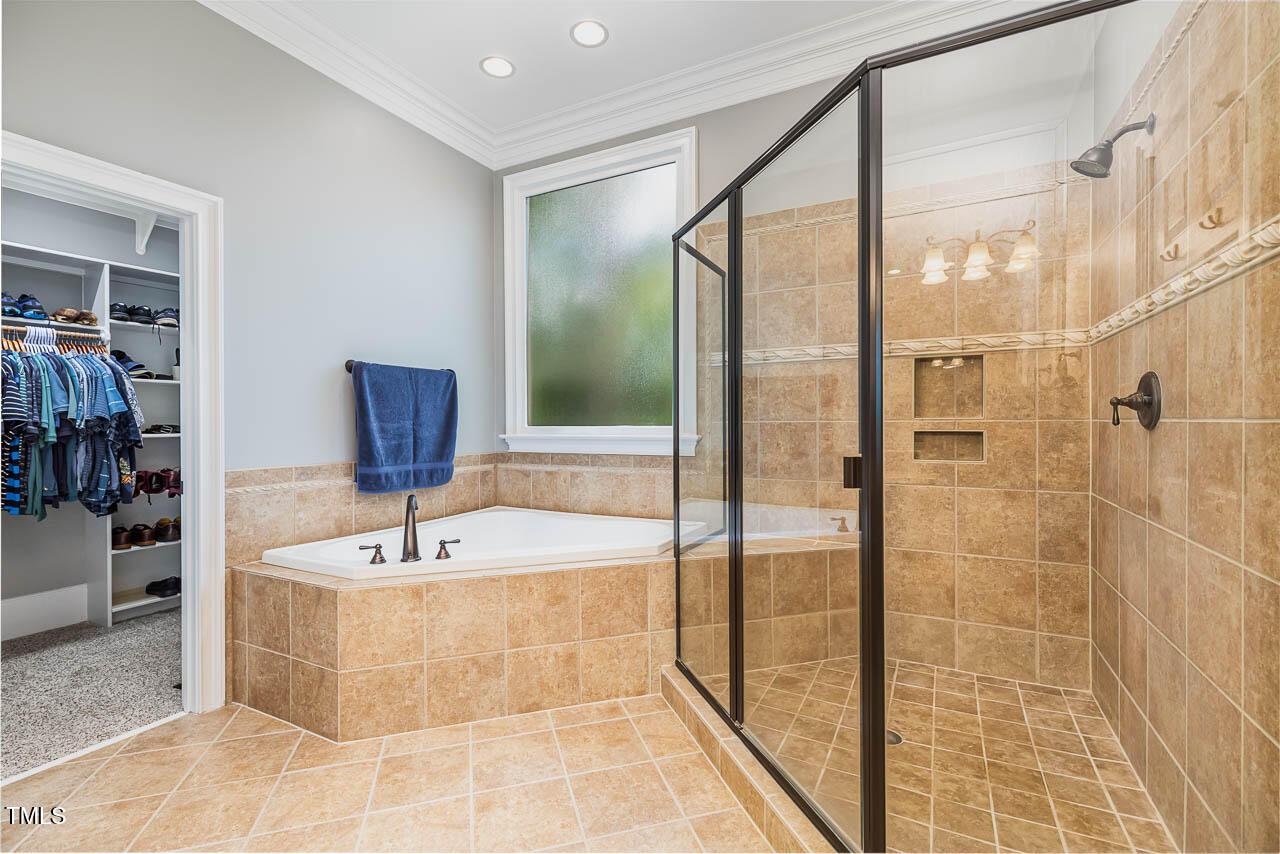 1097 Tacketts Pond Drive Raleigh, NC 27614 - Photo 16 of 38 a bathroom with a bathtub and a sink