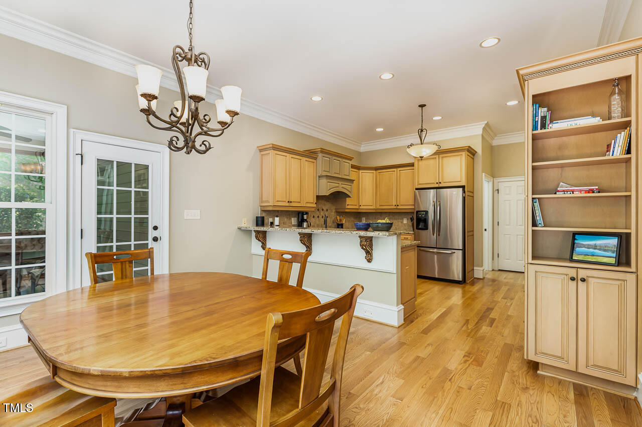 1097 Tacketts Pond Drive Raleigh, NC 27614 - Photo 19 of 38 a view of a dining room with furniture and wooden floor