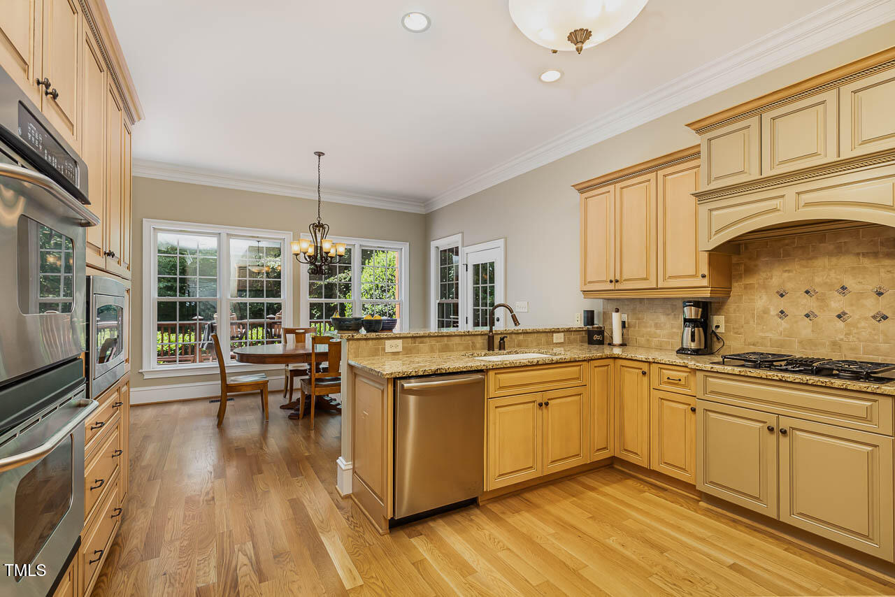 1097 Tacketts Pond Drive Raleigh, NC 27614 - Photo 20 of 38 a kitchen with stainless steel appliances granite countertop a stove and cabinets