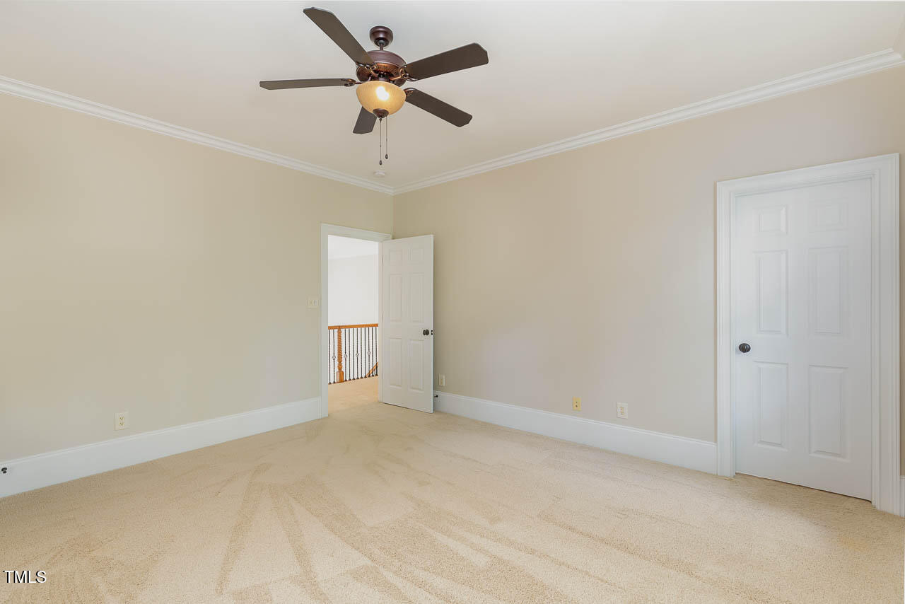 1097 Tacketts Pond Drive Raleigh, NC 27614 - Photo 29 of 38 an empty room with a ceiling fan and a window