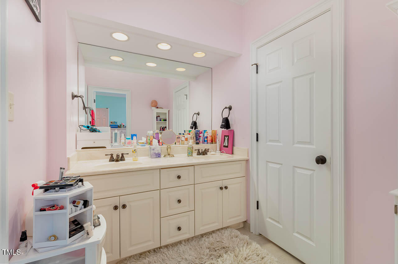 1097 Tacketts Pond Drive Raleigh, NC 27614 - Photo 30 of 38 a bathroom with a sink vanity and mirror