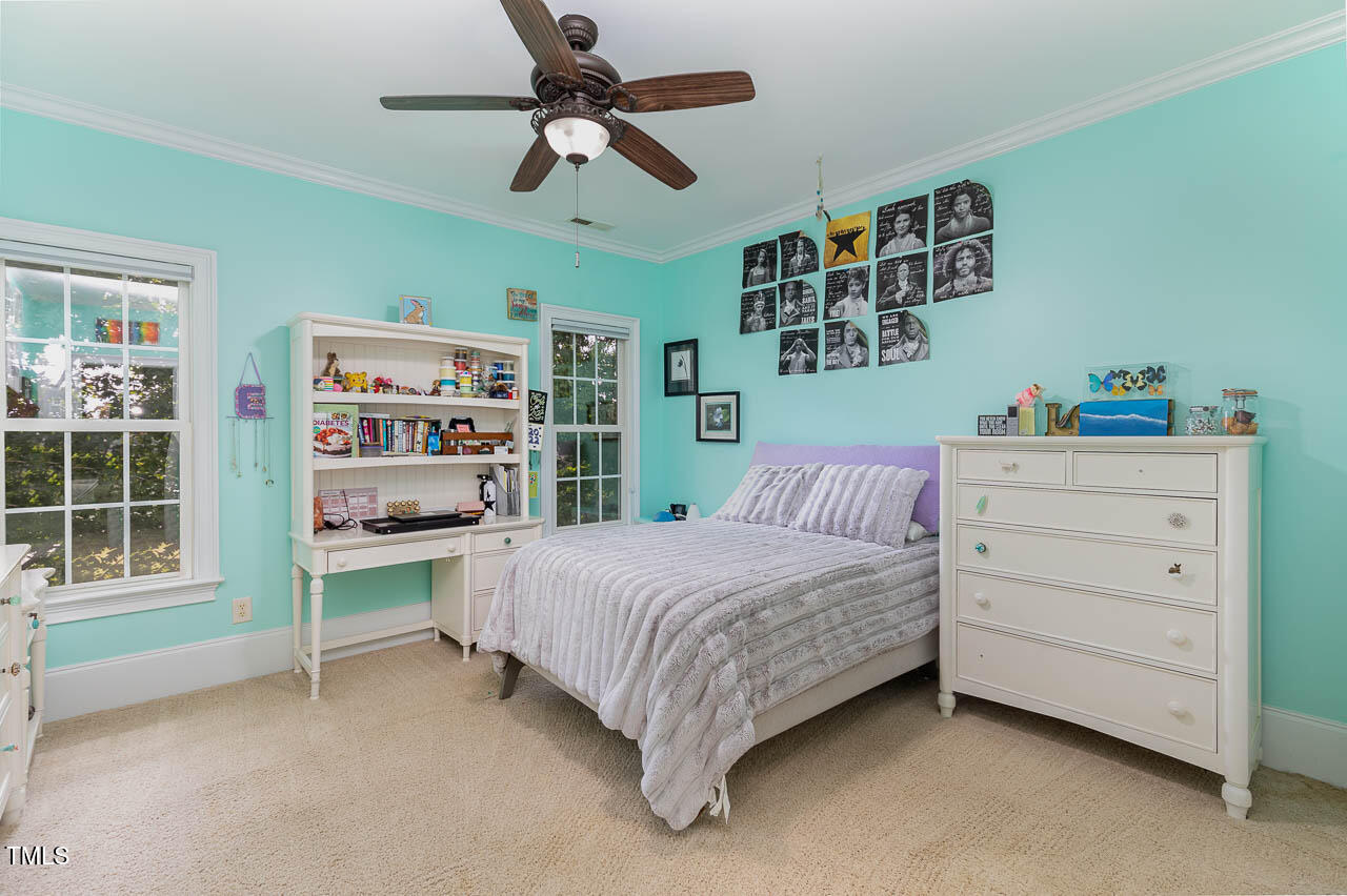 1097 Tacketts Pond Drive Raleigh, NC 27614 - Photo 31 of 38 a bedroom with a bed cabinets and window